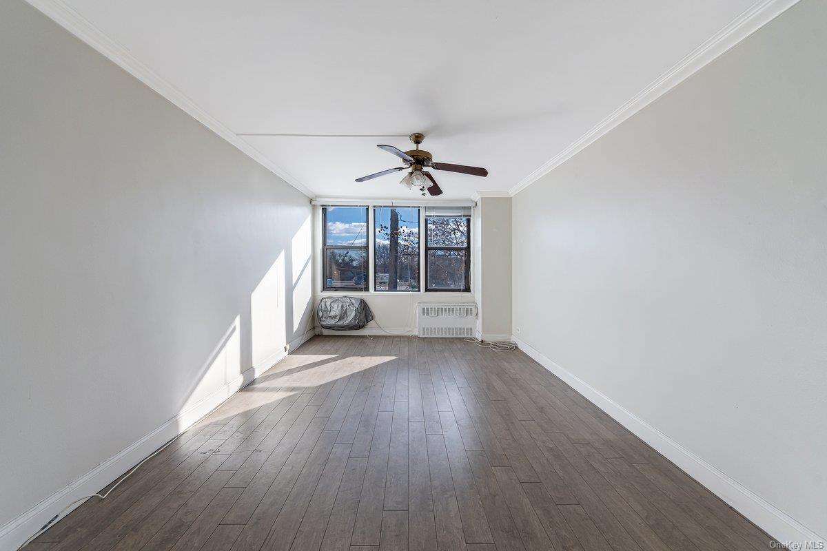 3121 Middletown Road, Unit 2K Bronx, NY 10461 - Photo 11 of 18 wooden floor in an empty room with a window