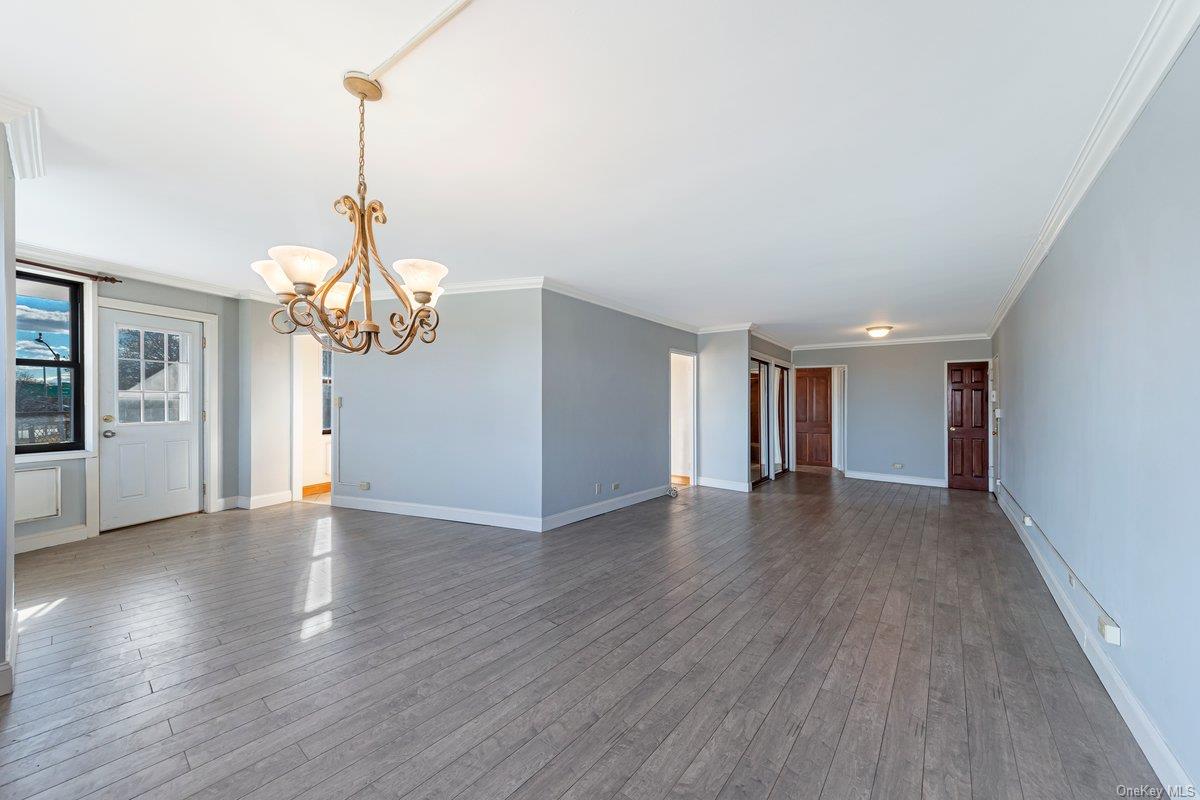 3121 Middletown Road, Unit 2K Bronx, NY 10461 - Photo 3 of 18 a view of a room with wooden floor chandelier and windows