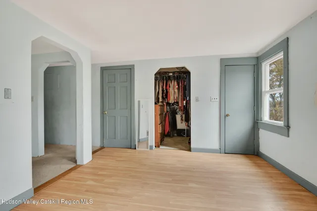 a view of a room that has a bed and a closet