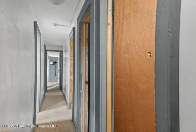 a view of a bathroom from a corridor