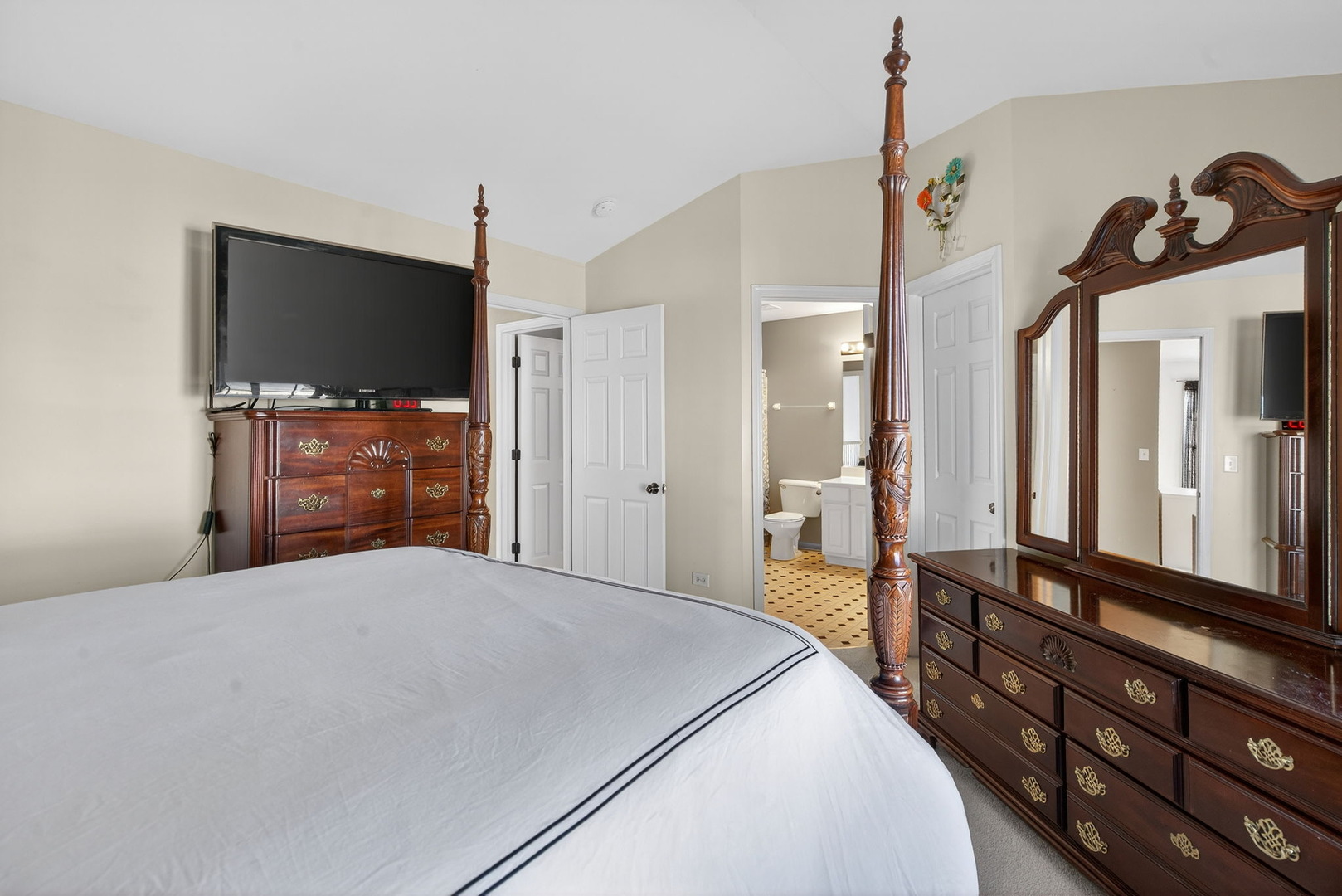 1429 Levato Lane Minooka, IL 60447 - Photo 15 of 27 a bedroom with a bed and a flat tv screen on dresser