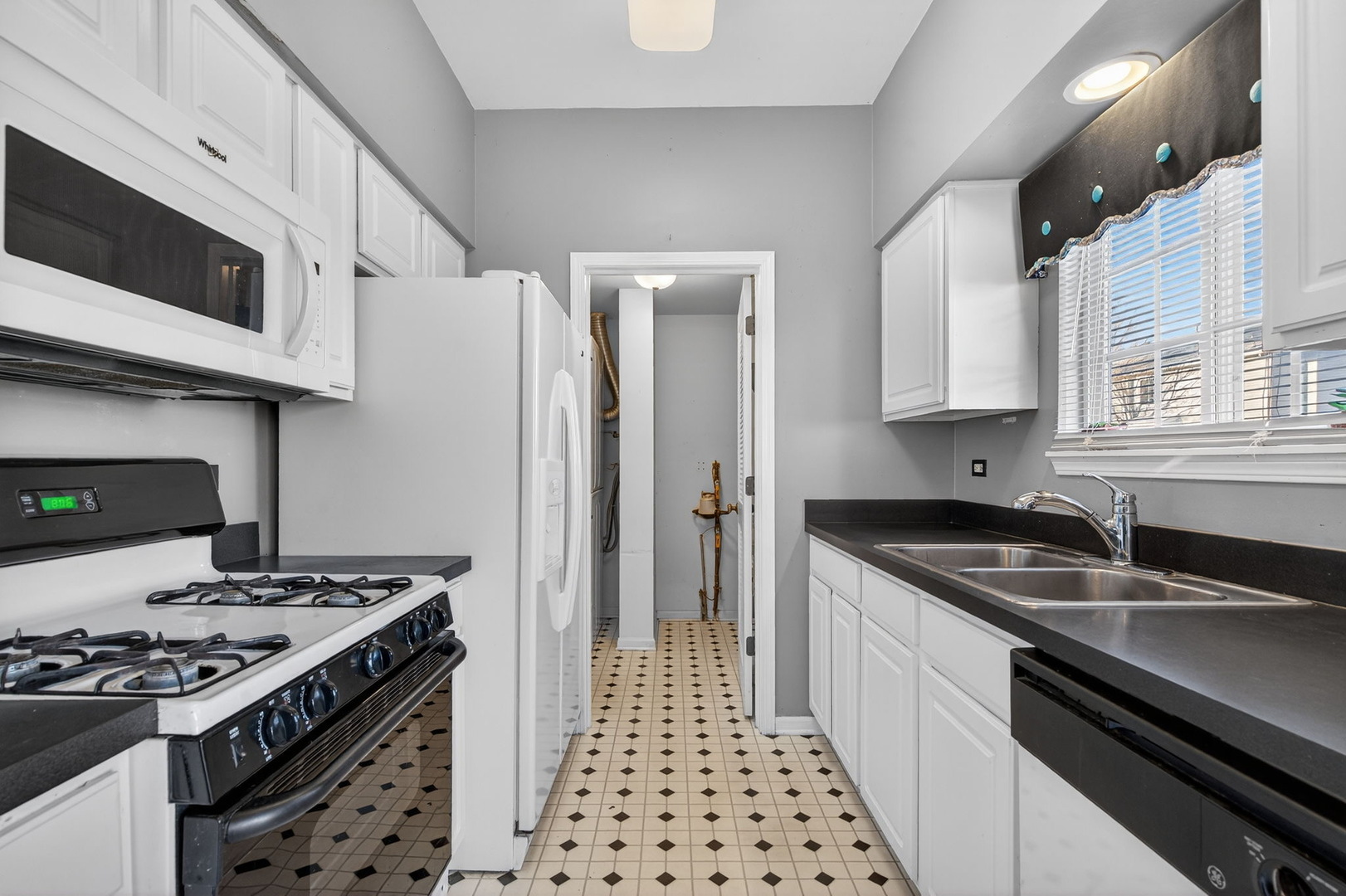 1429 Levato Lane Minooka, IL 60447 - Photo 7 of 27 a kitchen with stainless steel appliances granite countertop a stove and a sink