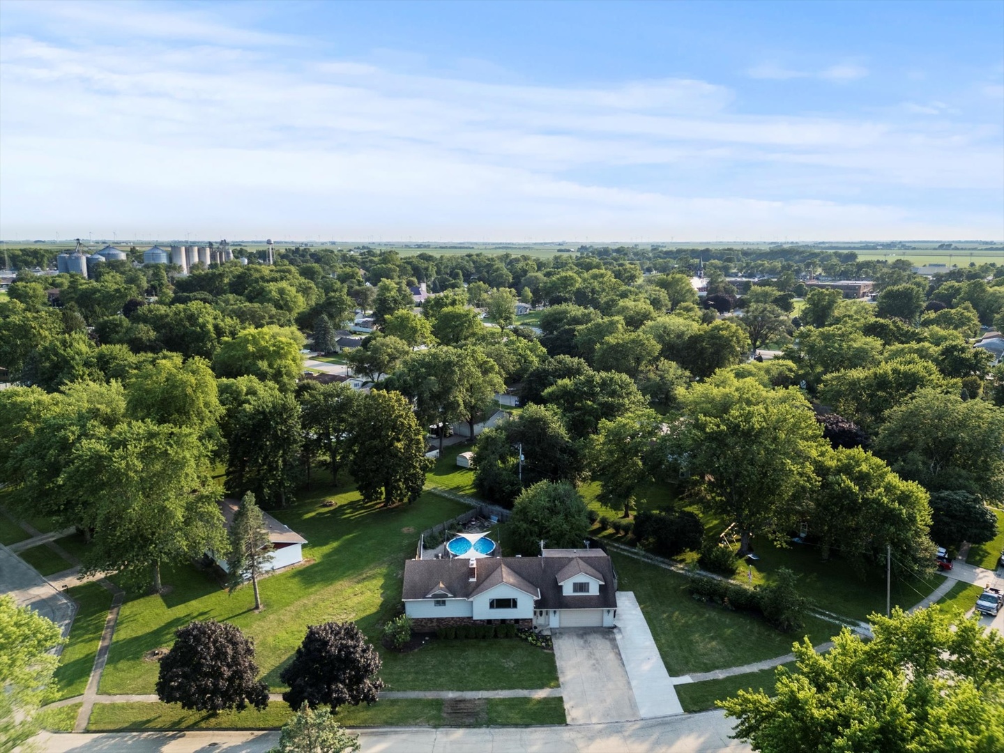 an aerial view of a house with garden space and street view