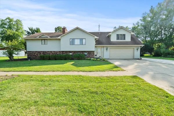 a view of a house with a yard and garage