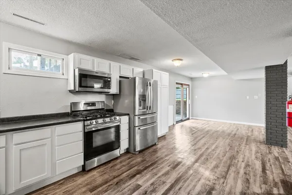 a kitchen with stove cabinets and refrigerator