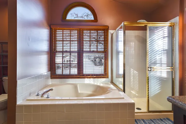 a bath tub sitting in a bathroom next to a window