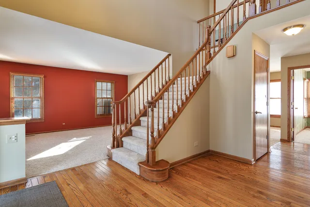 a view of entryway with wooden floor and stairs
