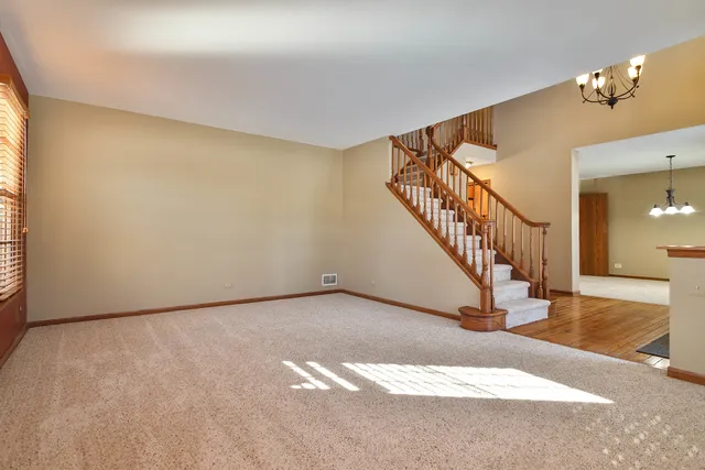 a view of an empty room with stairs