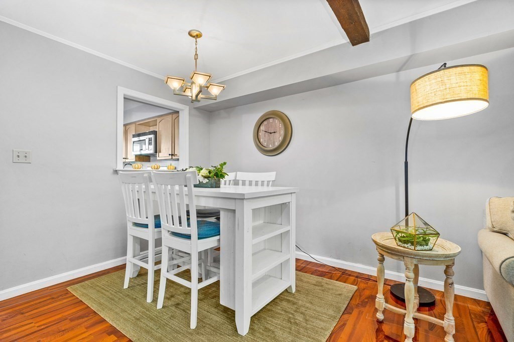 5 Beal's Cove Road, Unit B Hingham, MA 02043 - Photo 11 of 27 a view of a dining room with furniture and a chandelier