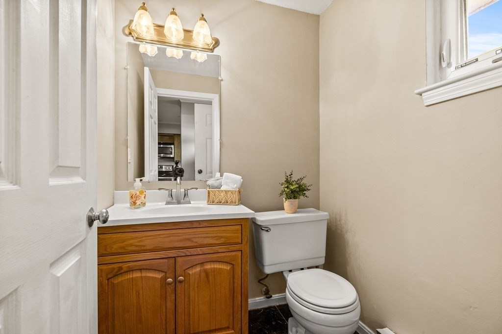 5 Beal's Cove Road, Unit B Hingham, MA 02043 - Photo 14 of 27 a bathroom with a sink a toilet a mirror and shower curtain