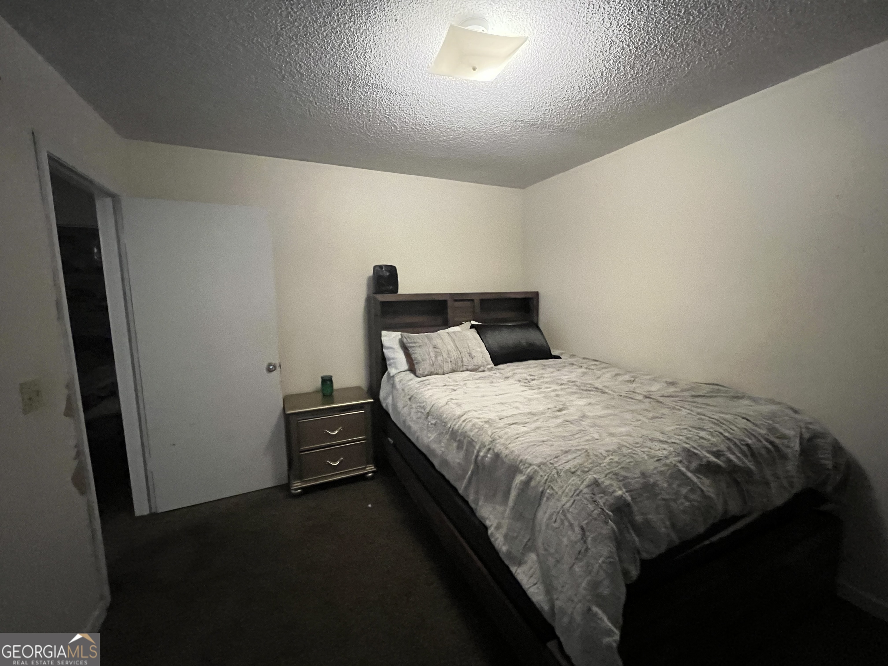 621 Pinewood Street Folkston, GA 31537 - Photo 11 of 14 a bed sitting in a bedroom next to a window