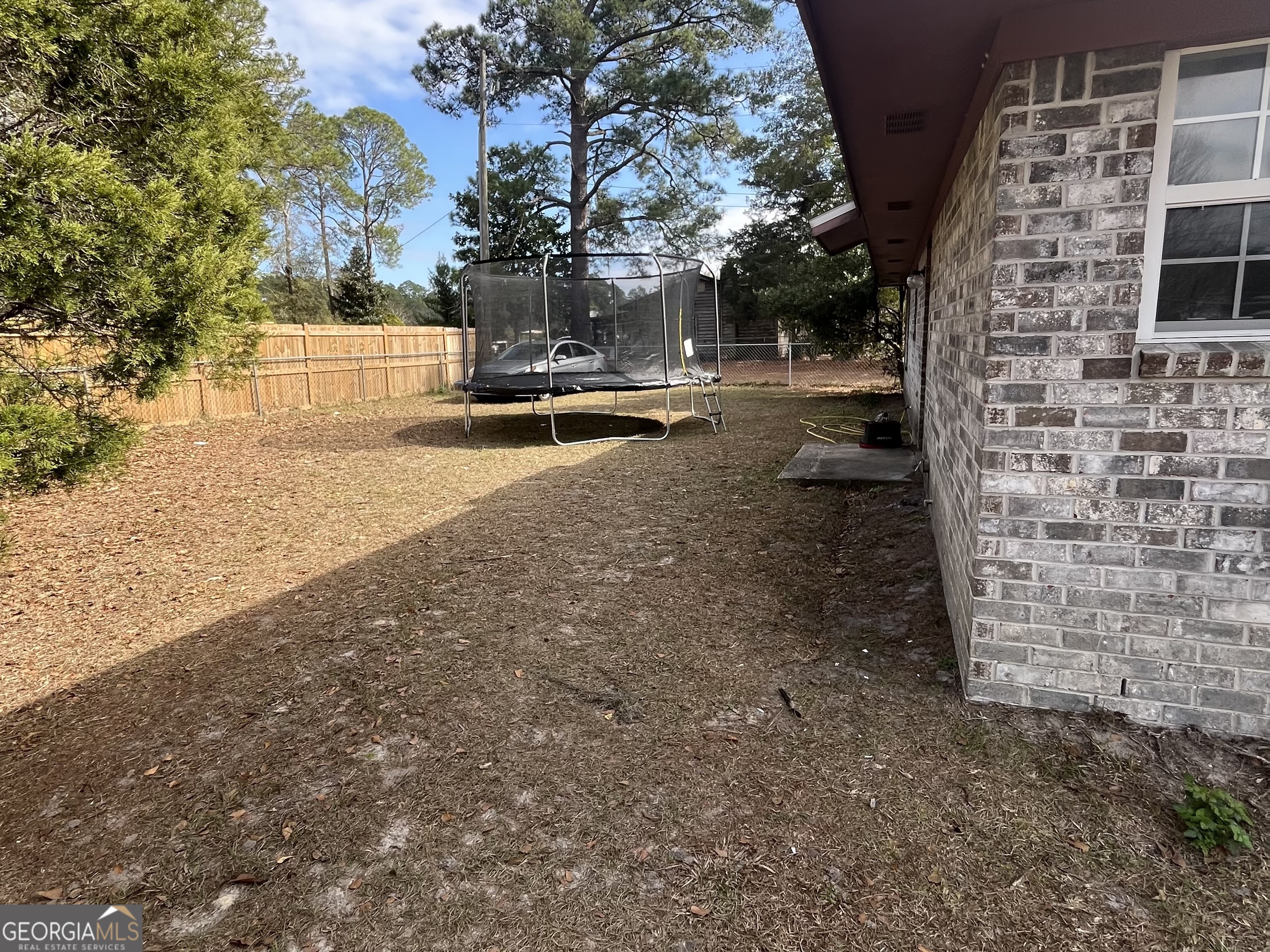 621 Pinewood Street Folkston, GA 31537 - Photo 14 of 14 a view of a yard with cars