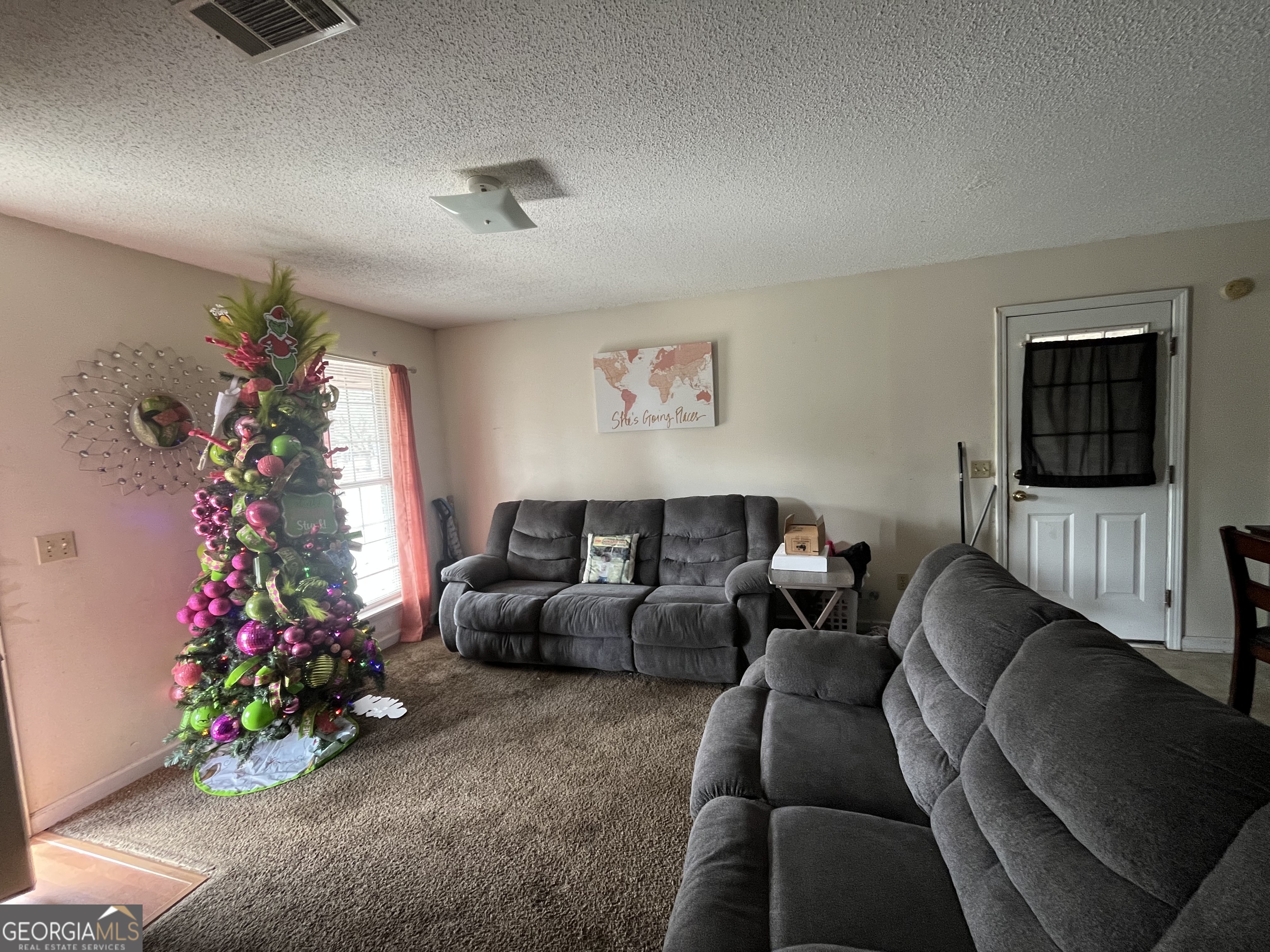 621 Pinewood Street Folkston, GA 31537 - Photo 4 of 14 a living room with furniture and a potted plant