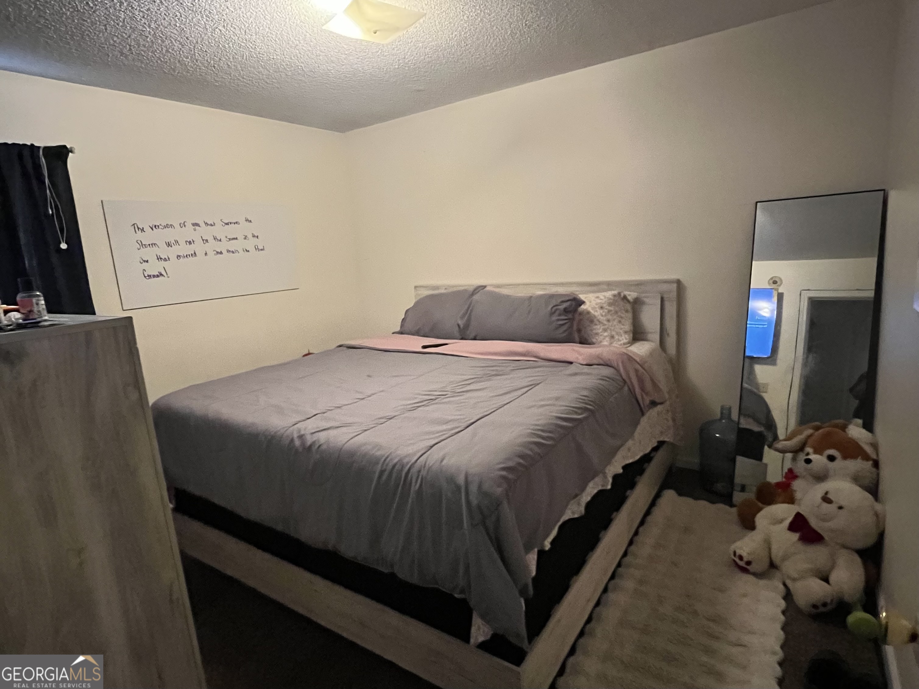 621 Pinewood Street Folkston, GA 31537 - Photo 8 of 14 a bedroom with a bed and a flat tv screen on the dresser