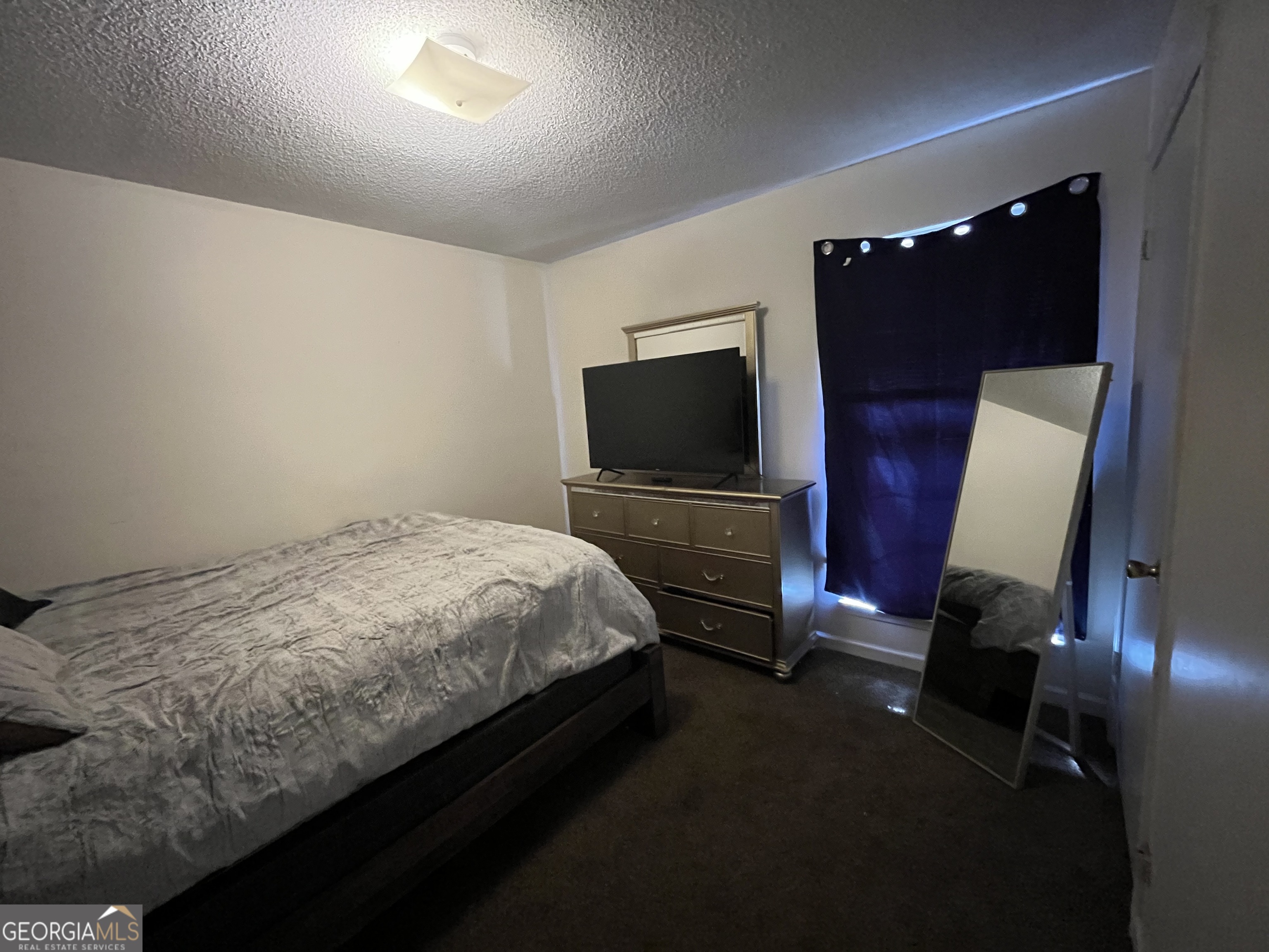 621 Pinewood Street Folkston, GA 31537 - Photo 10 of 14 a bedroom with a bed tv and a dresser