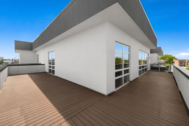 a view of a bedroom with wooden floor and a sink