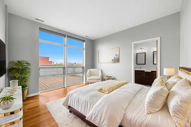 a bedroom with a large bed and a large window
