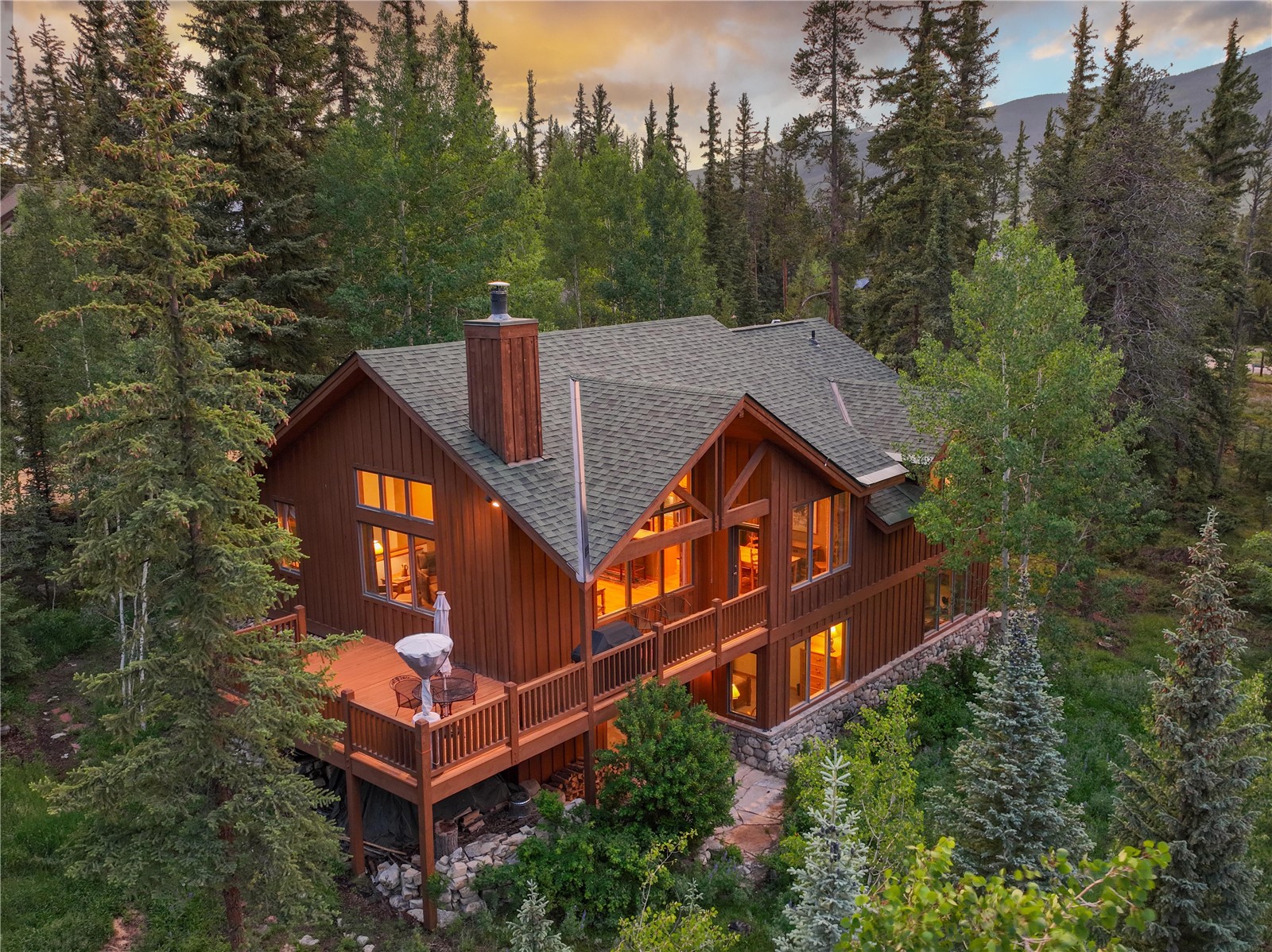 760 Penstemon Road Keystone, CO 80435 - Photo 1 of 39 Back house at dusk featuring a wooden deck
