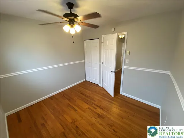 a view of an empty room with wooden floor