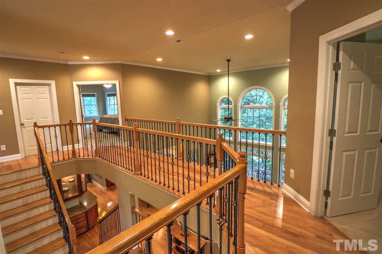 2408 Loring Court Raleigh, NC 27613 - Photo 14 of 25 a view of staircase with railing and a chandelier