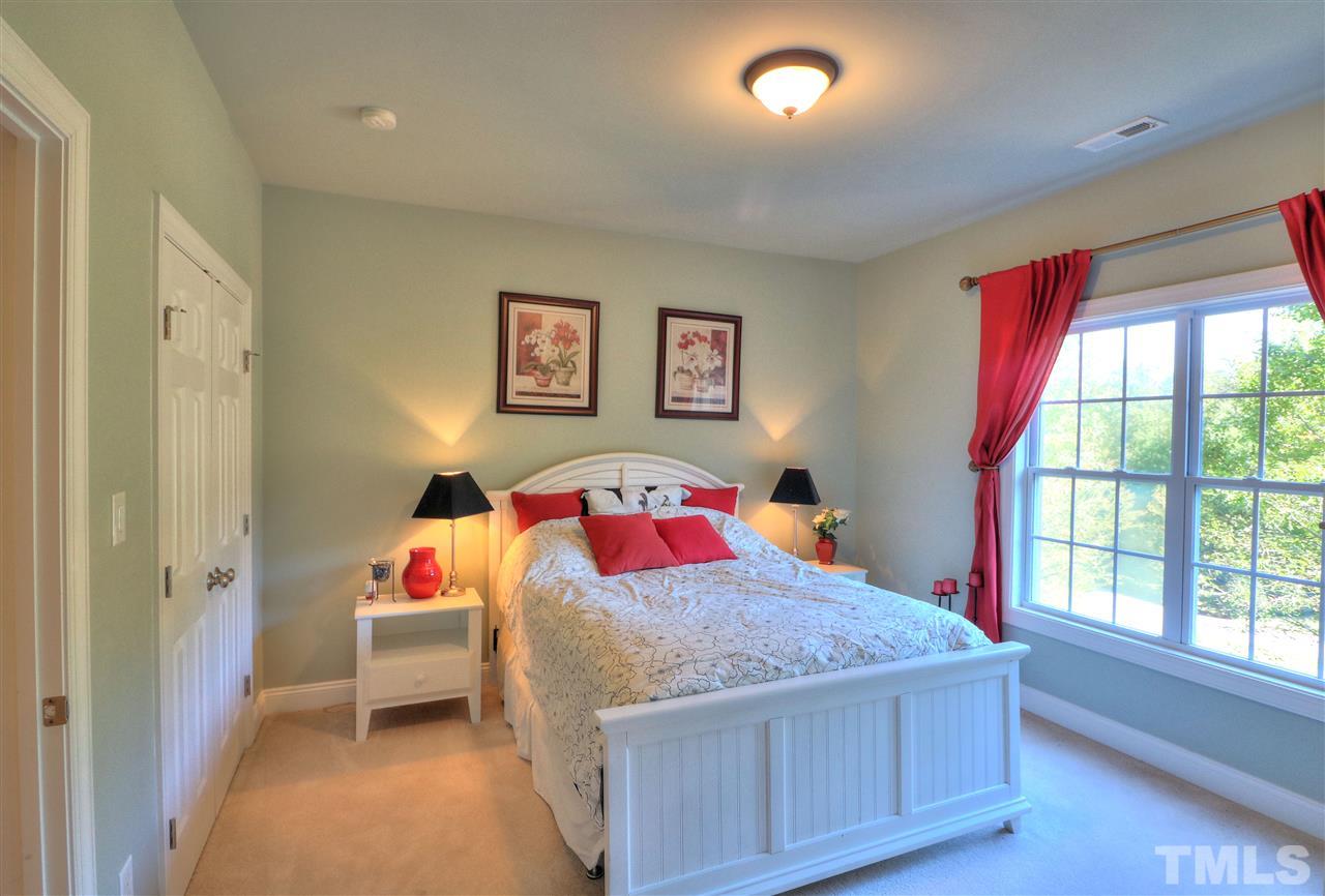 2408 Loring Court Raleigh, NC 27613 - Photo 15 of 25 a bedroom with a bed and a window