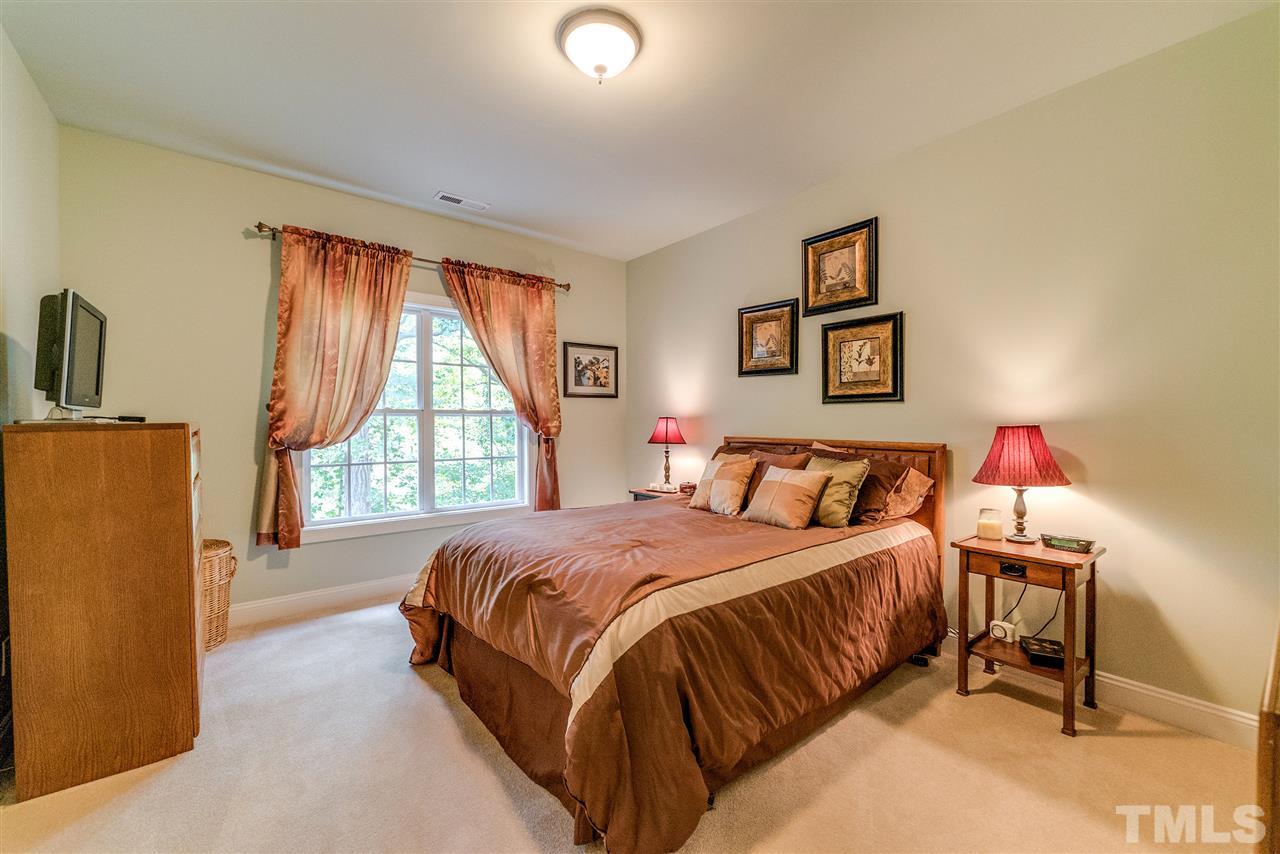 2408 Loring Court Raleigh, NC 27613 - Photo 16 of 25 a bedroom with a bed and a window