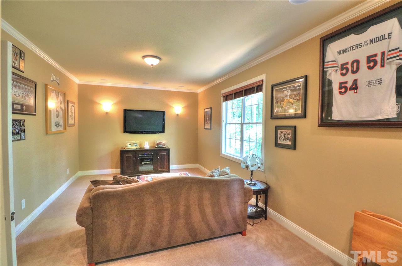 2408 Loring Court Raleigh, NC 27613 - Photo 19 of 25 a bedroom with a bed and a flat screen tv
