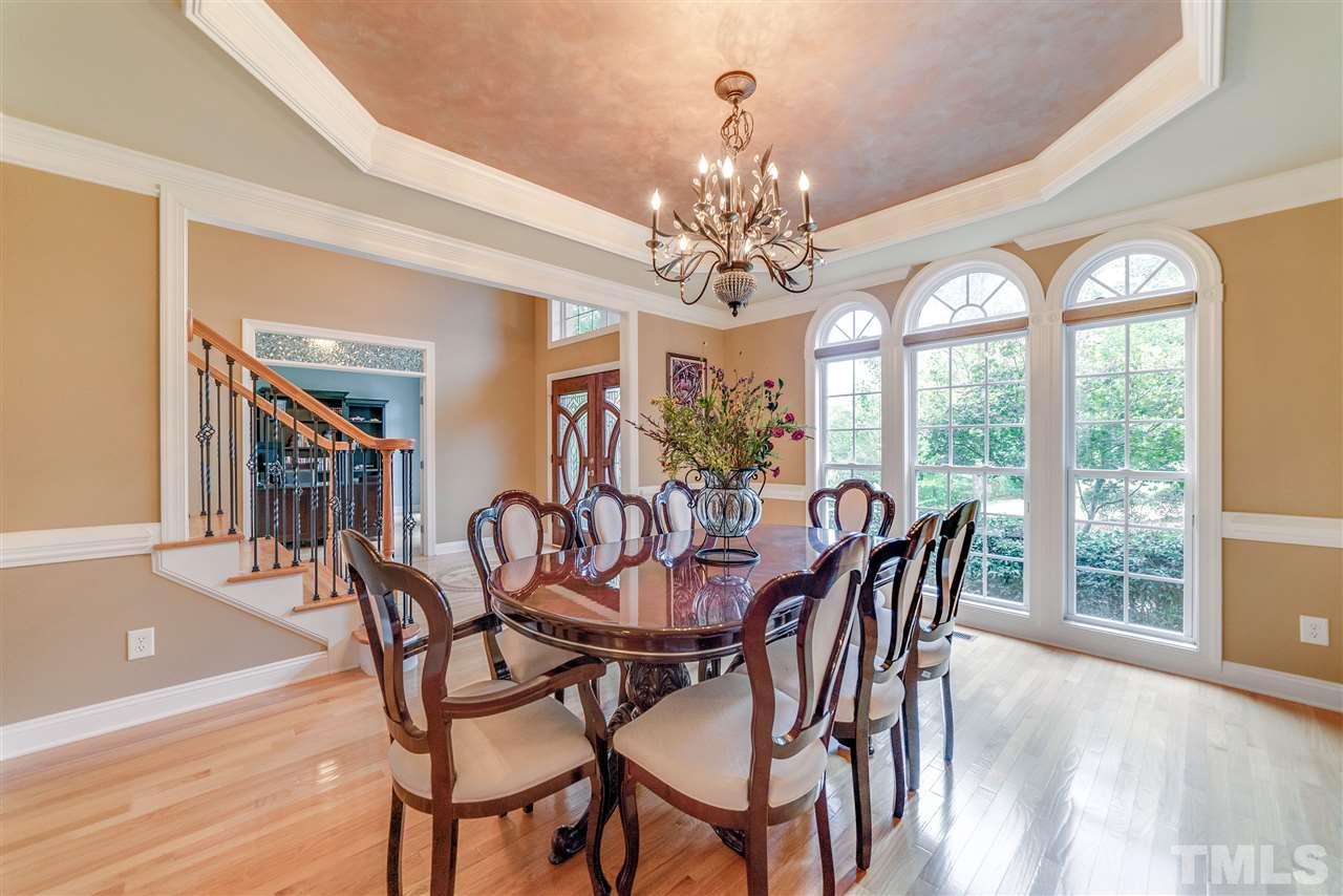 2408 Loring Court Raleigh, NC 27613 - Photo 3 of 25 a view of a dining room with furniture a chandelier and wooden floor