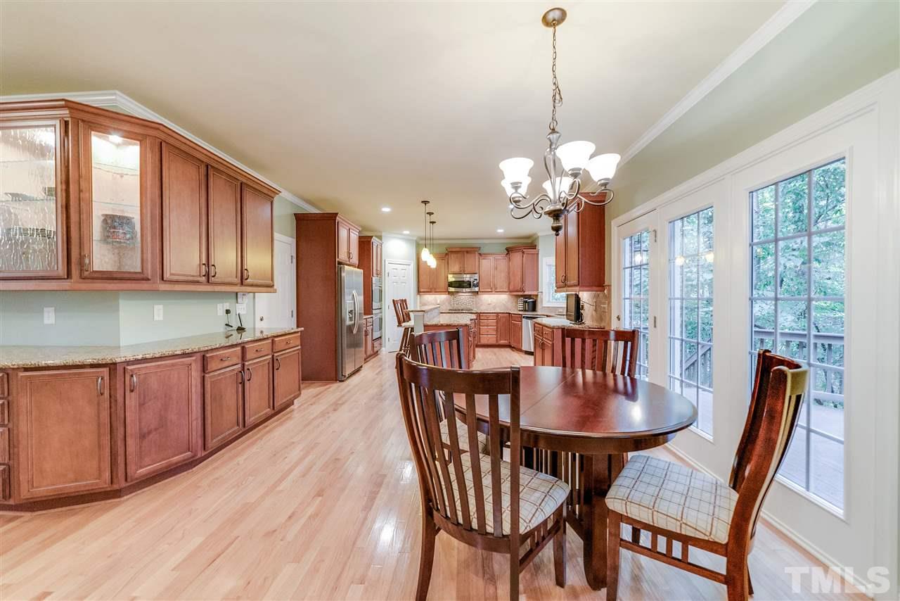 2408 Loring Court Raleigh, NC 27613 - Photo 4 of 25 a view of a dining room with furniture window and wooden floor