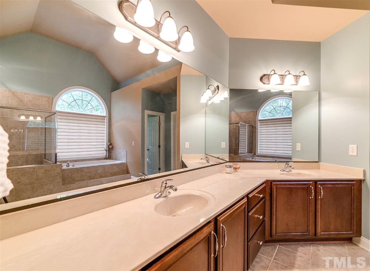 2408 Loring Court Raleigh, NC 27613 - Photo 10 of 25 a bathroom with a sink and a mirror