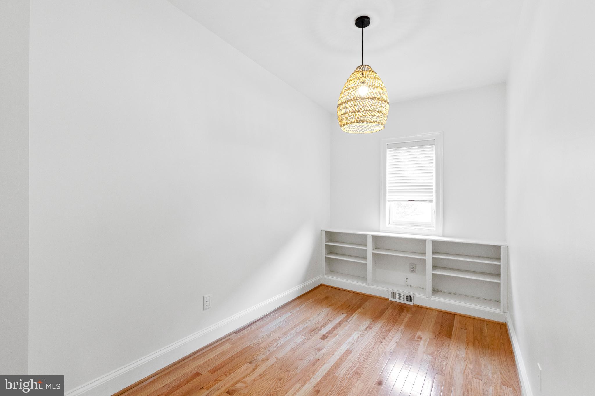 431 4th Street Northeast Washington, DC 20002 - Photo 17 of 37 a view of a room with wooden floor and white walls