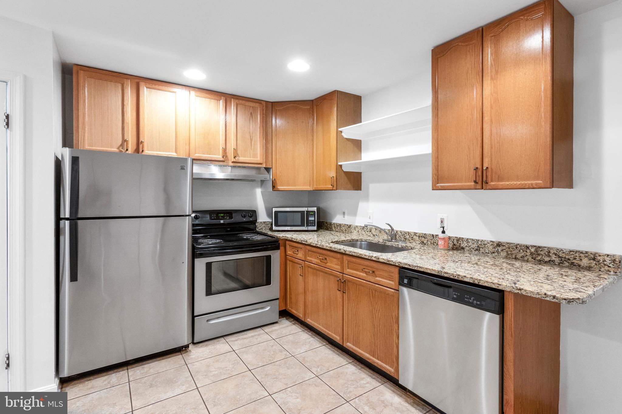 431 4th Street Northeast Washington, DC 20002 - Photo 23 of 37 a kitchen with stainless steel appliances granite countertop a sink stove and refrigerator