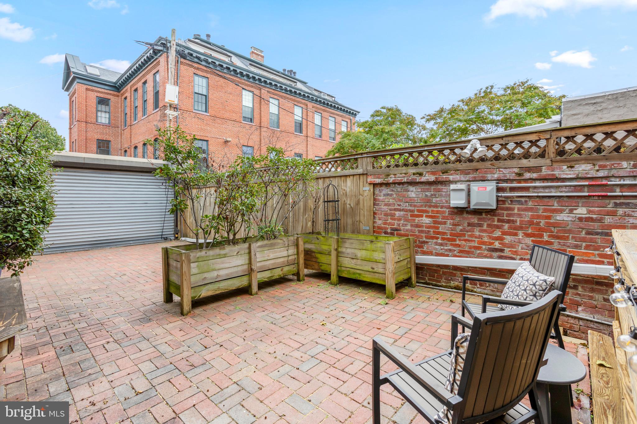 431 4th Street Northeast Washington, DC 20002 - Photo 32 of 37 a balcony with a bench and some potted plants