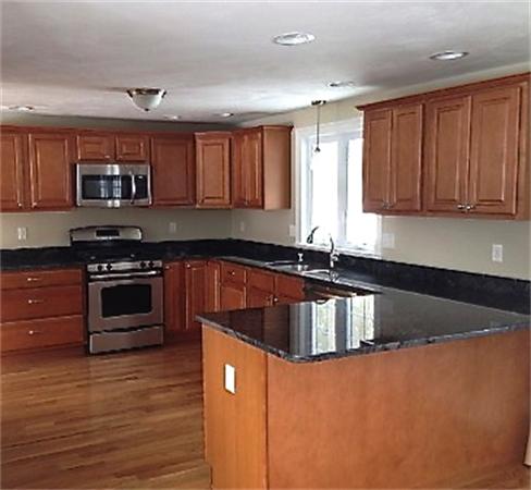 19 Shawnee Road, Unit 1 Pepperell, MA 01463 - Photo 9 of 18 a kitchen with stainless steel appliances granite countertop a stove a sink and a microwave