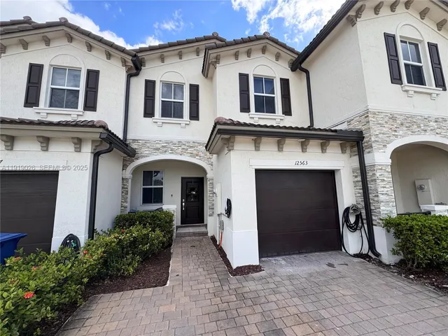 a front view of a house with yard