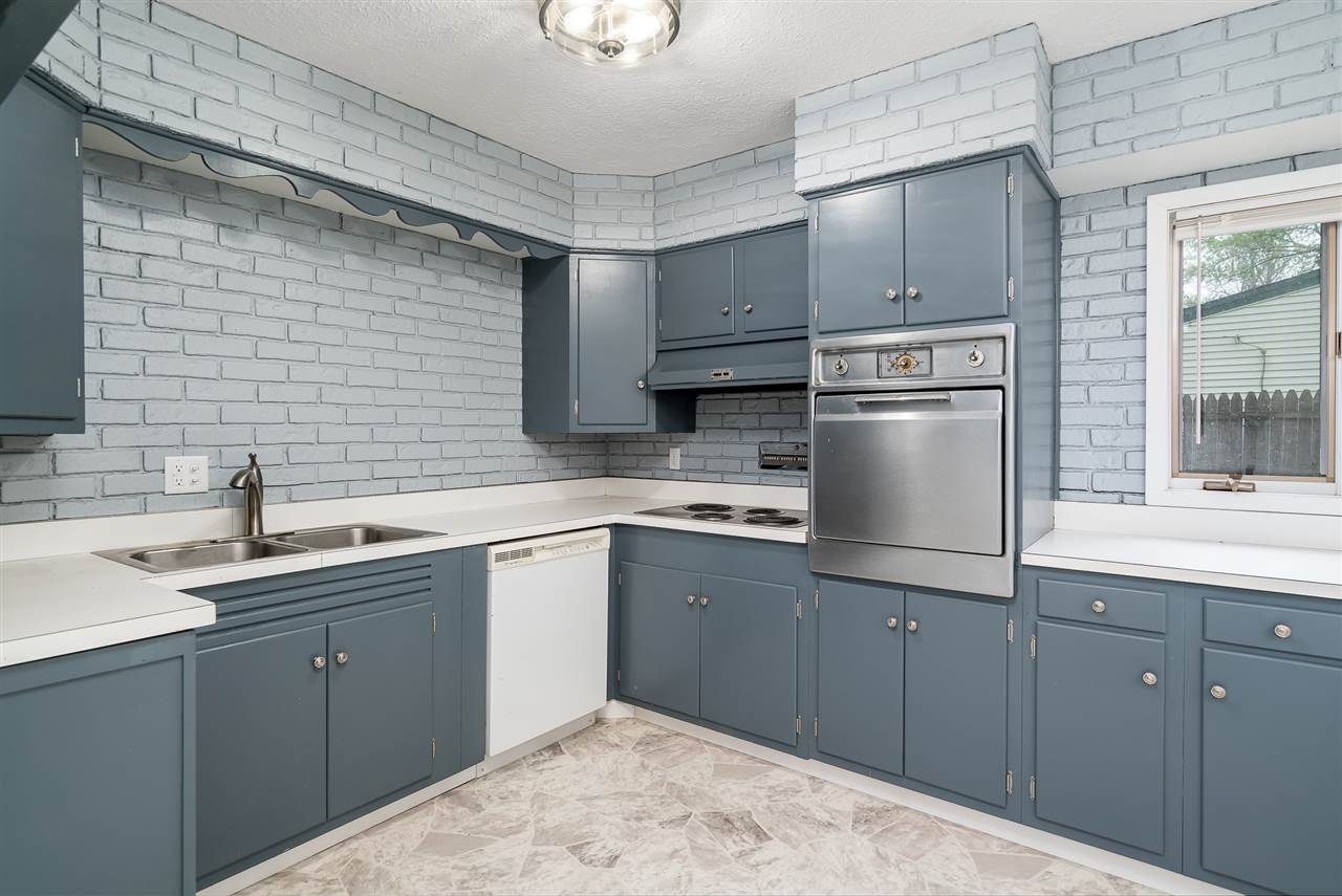 5114 Highcrest Road Rockford, IL 61107 - Photo 12 of 36 a kitchen with a sink cabinets and appliances