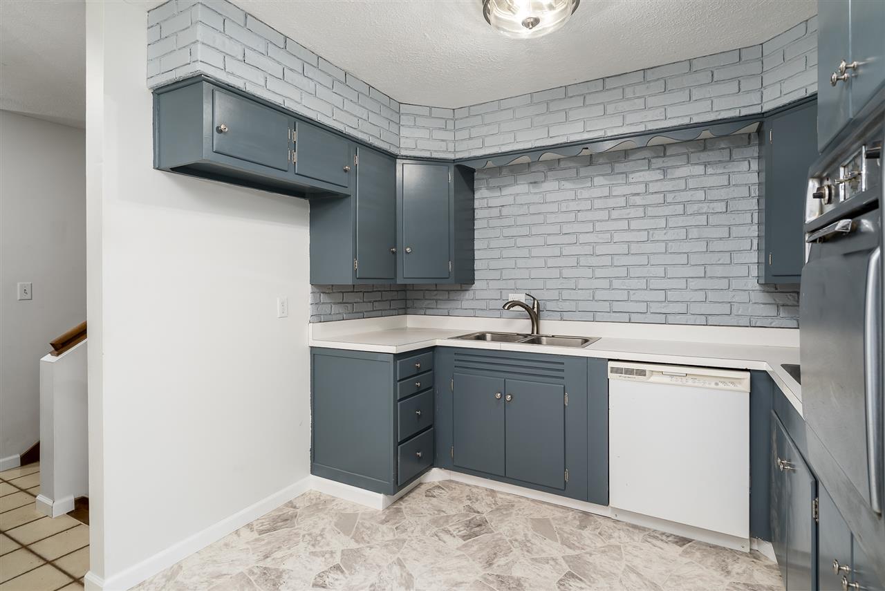 5114 Highcrest Road Rockford, IL 61107 - Photo 14 of 36 a kitchen with a sink cabinets and a wooden floor