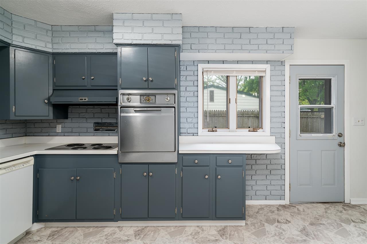 5114 Highcrest Road Rockford, IL 61107 - Photo 15 of 36 a kitchen with granite countertop a sink and a stove