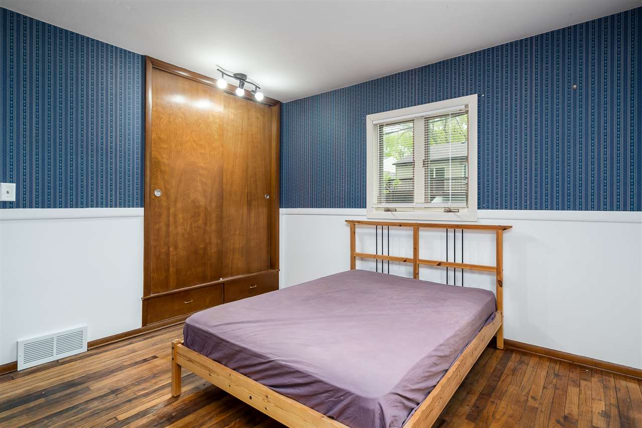 5114 Highcrest Road Rockford, IL 61107 - Photo 20 of 36 a bedroom with a bed and wooden floor