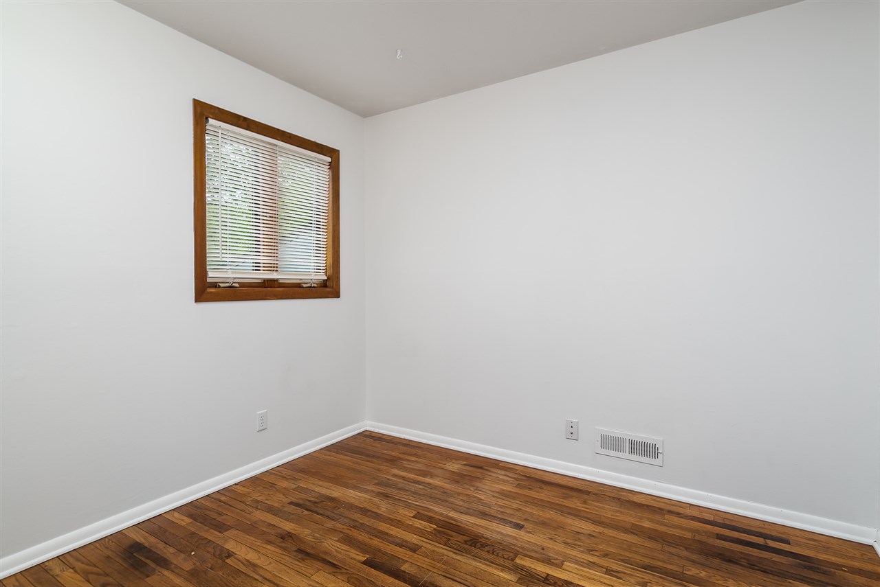 5114 Highcrest Road Rockford, IL 61107 - Photo 23 of 36 a view of an empty room with wooden floor and a window
