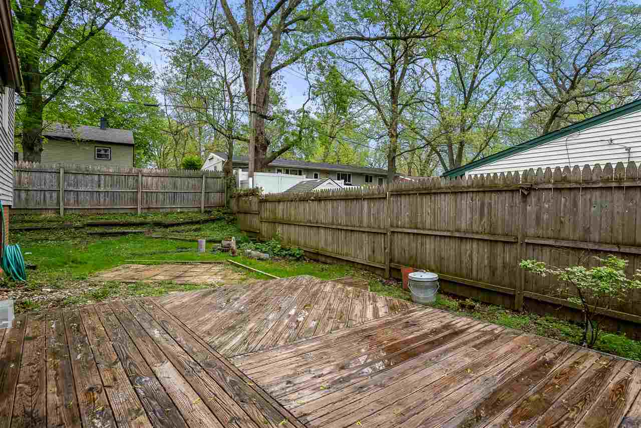 5114 Highcrest Road Rockford, IL 61107 - Photo 35 of 36 a view of a backyard with a wooden fence