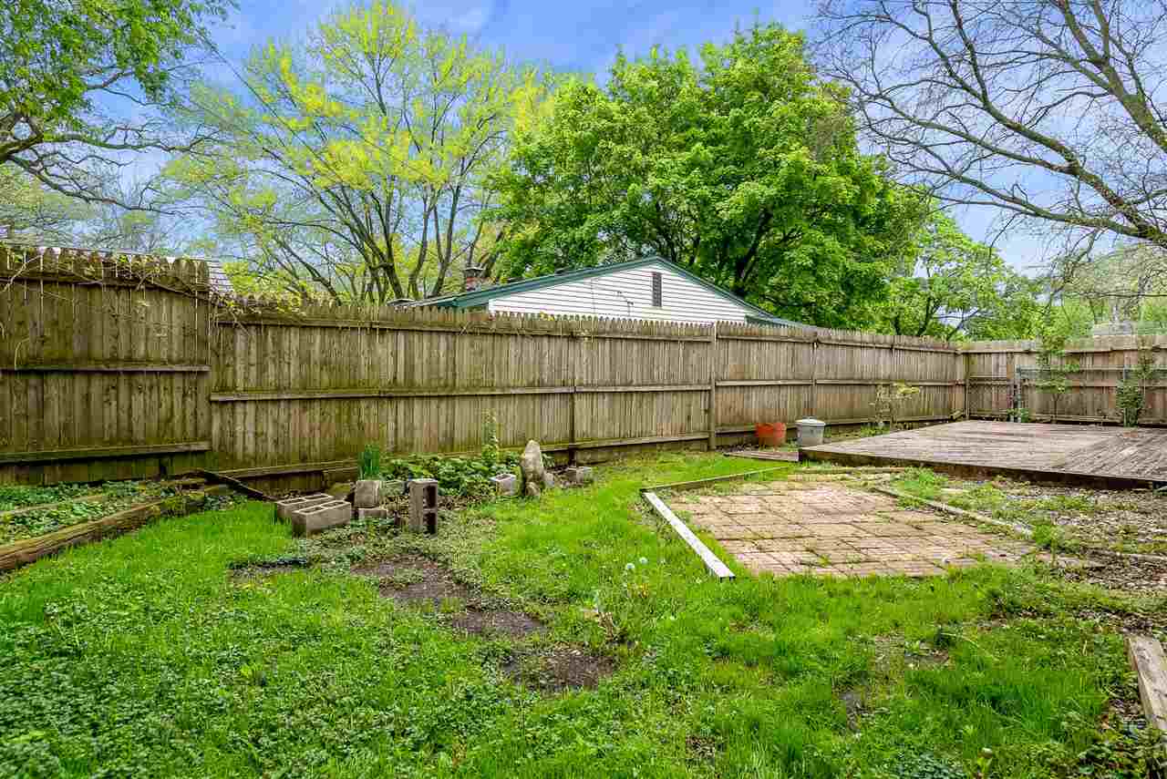5114 Highcrest Road Rockford, IL 61107 - Photo 36 of 36 a view of a backyard with a small cabin and a chair