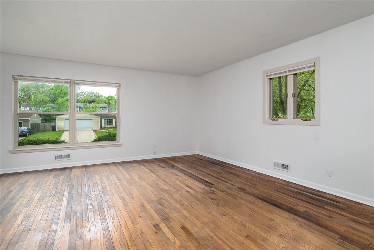 5114 Highcrest Road Rockford, IL 61107 - Photo 6 of 36 a view of an empty room with wooden floor and a window