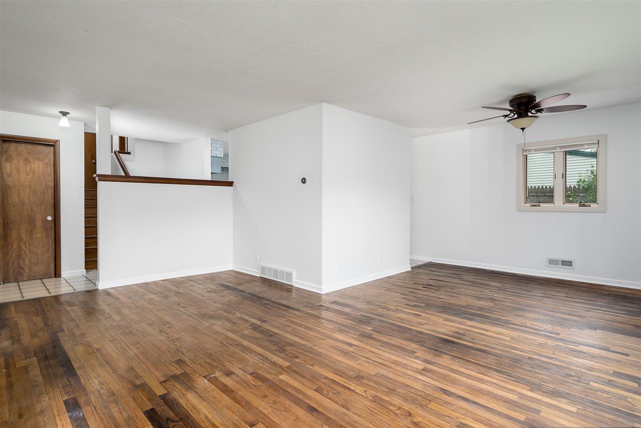 5114 Highcrest Road Rockford, IL 61107 - Photo 8 of 36 a view of empty room with wooden floor and fan