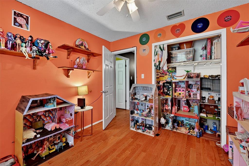 813 Glen Key Street Denison, TX 75020 - Photo 15 of 28 Misc room featuring ceiling fan, a textured ceiling, and wood finished floors