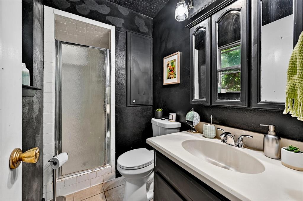 813 Glen Key Street Denison, TX 75020 - Photo 19 of 28 Full bathroom featuring a shower stall, vanity, tile patterned floors, and a textured wall