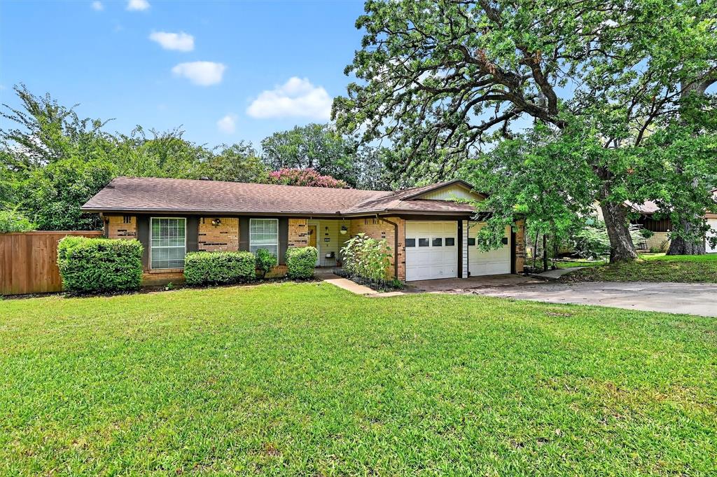 813 Glen Key Street Denison, TX 75020 - Photo 2 of 28 Single story home with concrete driveway, a garage, brick siding, and a shingled roof