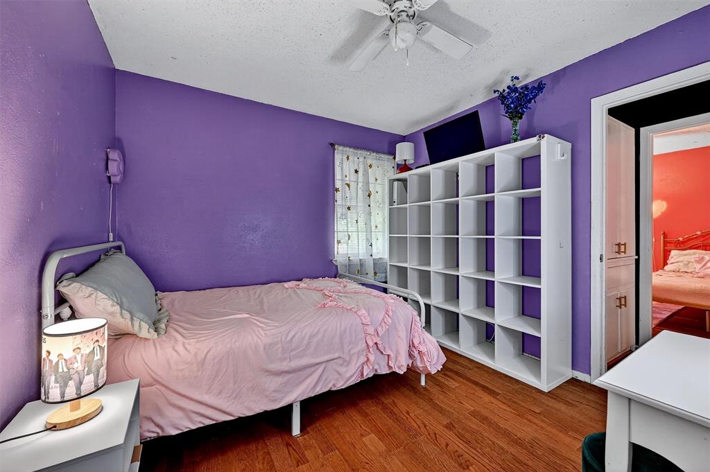 813 Glen Key Street Denison, TX 75020 - Photo 24 of 28 Bedroom featuring wood finished floors, a textured ceiling, and ceiling fan