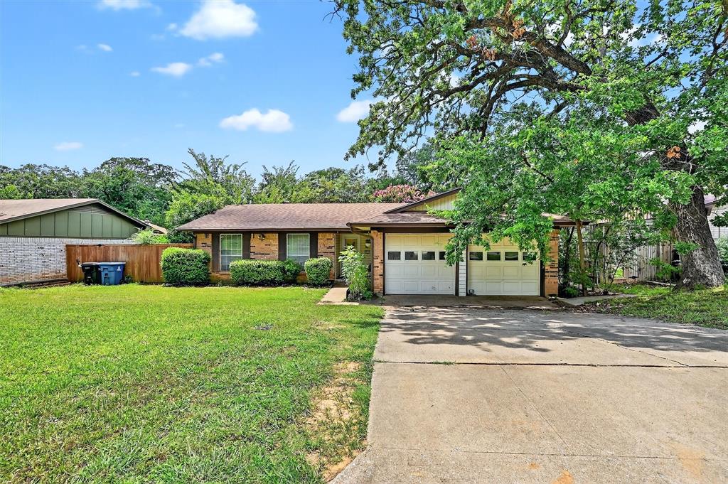 813 Glen Key Street Denison, TX 75020 - Photo 3 of 28 View of front of home with concrete driveway, brick siding, a garage, and a shingled roof