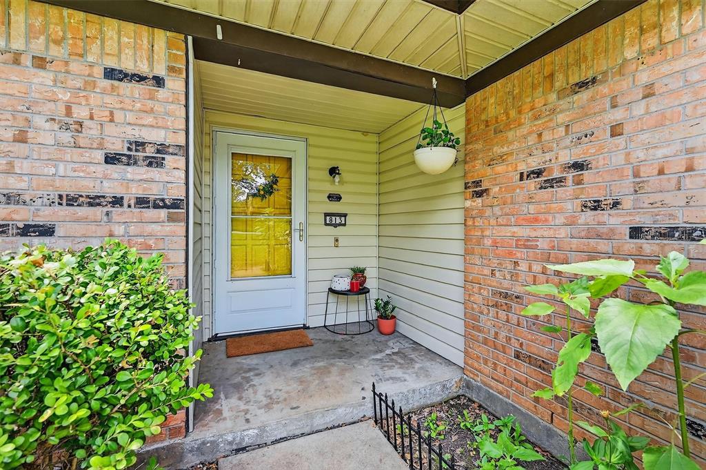 813 Glen Key Street Denison, TX 75020 - Photo 4 of 28 View of exterior entry featuring brick siding and covered porch